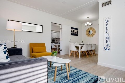 A living room with a grey couch, a yellow chair, a white coffee table, and a white dining table with chairs.