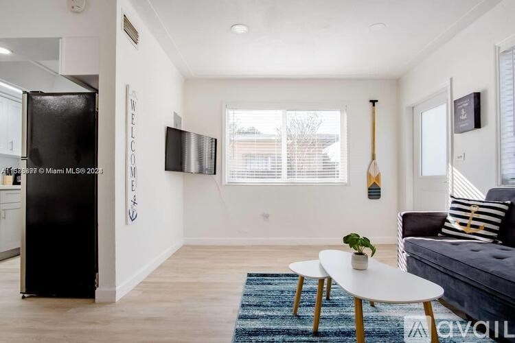 A living room with a couch, a table, and a TV.