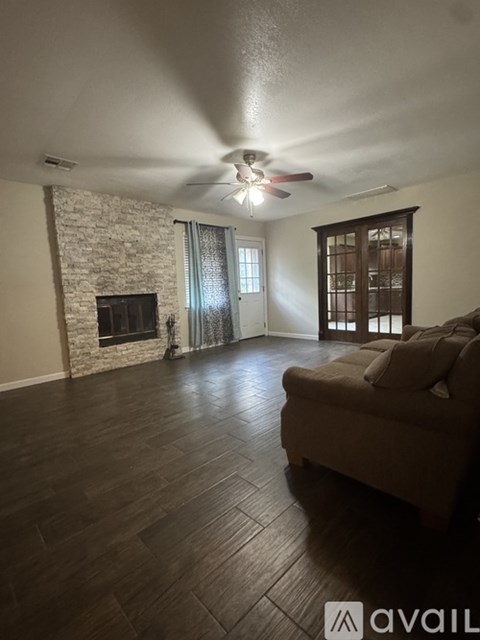 A living room with a couch and a fireplace.