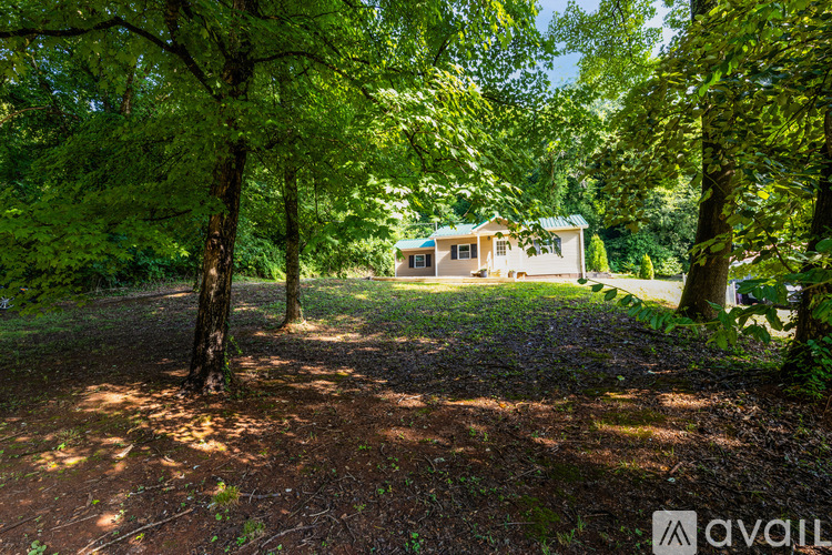 A house is surrounded by trees in a wooded area.