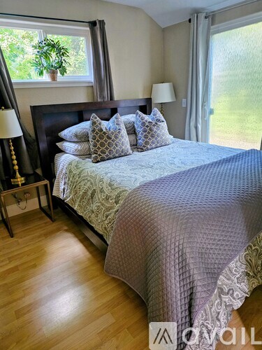 A bedroom with a large bed and a window.