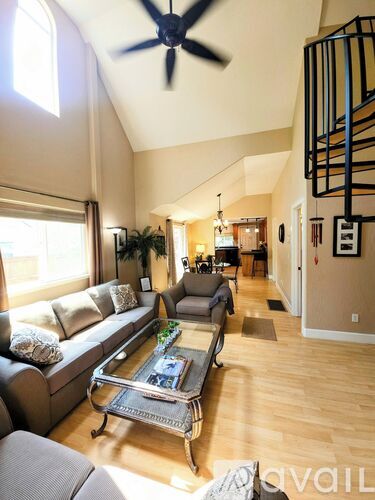 A living room with a grey couch and a coffee table.
