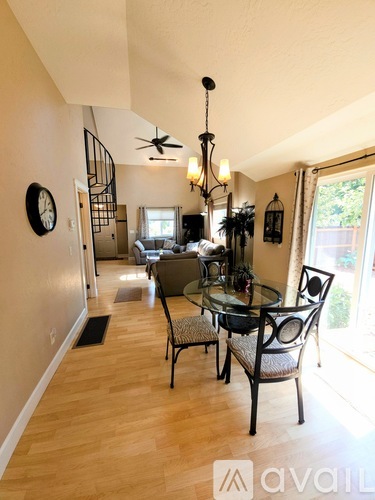 A dining room with a glass table and chairs.