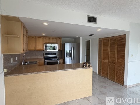 A kitchen with wooden cabinets and a countertop.