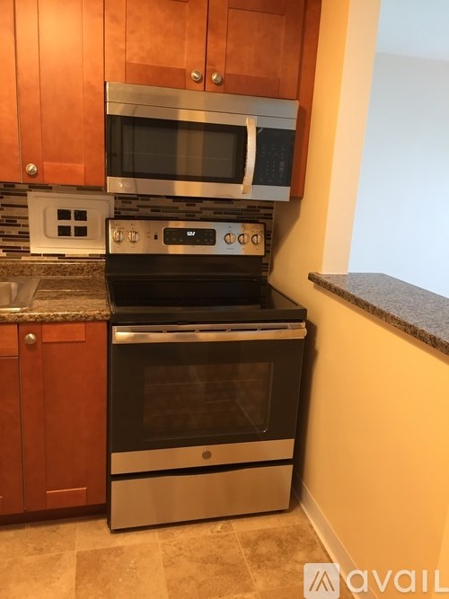 A kitchen with a stove top oven and microwave above it.