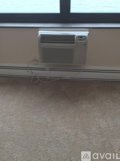 A wall-mounted air conditioning unit is installed in a room.