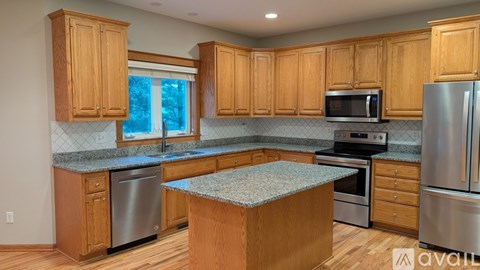 A kitchen with wooden cabinets and stainless steel appliances.