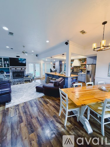 A large open plan living and dining area with a wooden table and chairs.