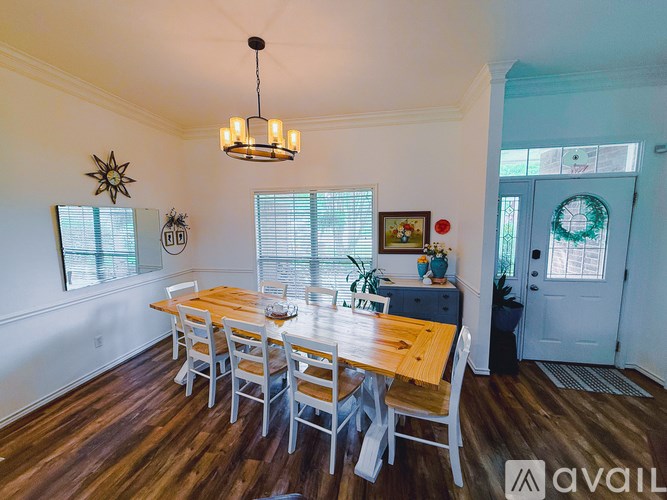 A dining room with a wooden table and chairs.