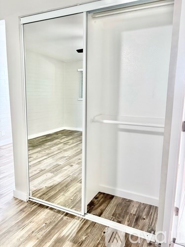 A white door with a glass window is open.