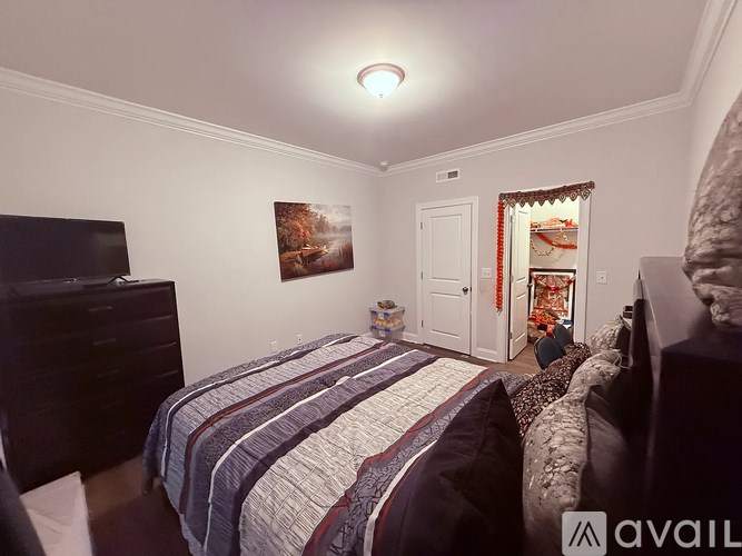 A bedroom with two beds and a dresser.