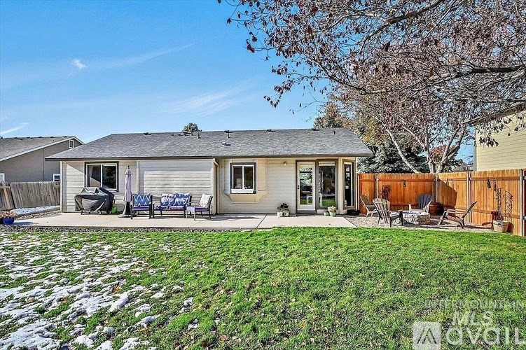 A house with a grey roof and a green lawn in front.