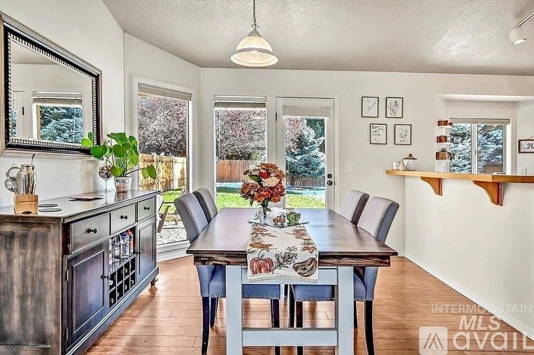 A dining room with a wooden table and chairs.