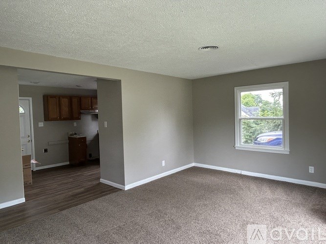 A room with a car parked outside the window.