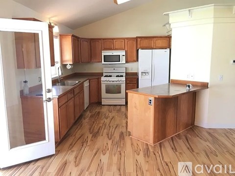 A kitchen with wooden cabinets and a white refrigerator.