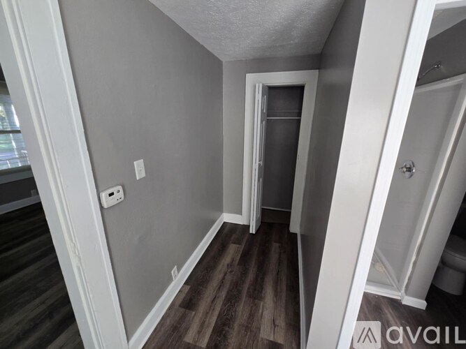 A small, empty room with a doorway leading to another room.