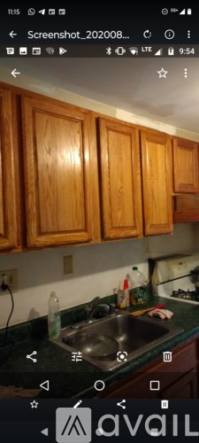 A kitchen with wooden cabinets and a granite countertop.