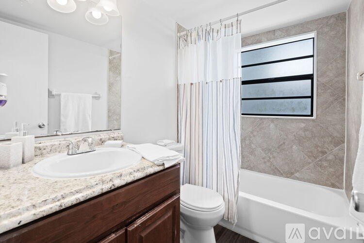 A bathroom with a white sink and a white toilet.