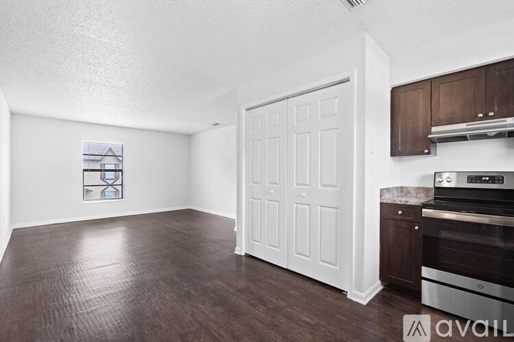 A kitchen area with a stove top oven and a white door.
