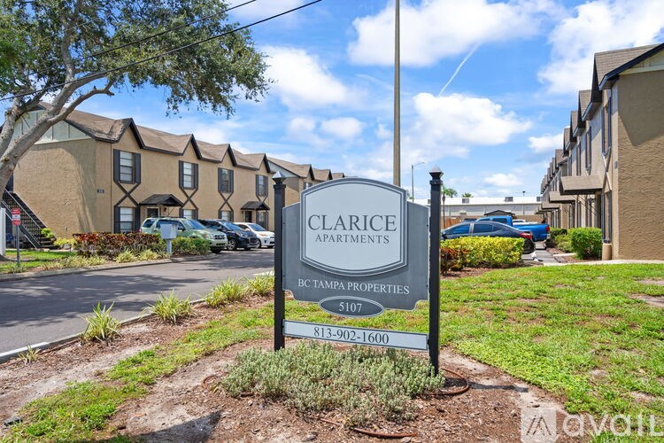A Clarice Apartments sign is in front of a building.