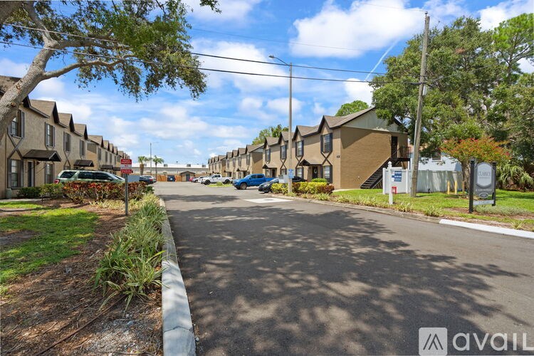 A street view of a residential area with houses on both sides and a car parked on the side of the road.