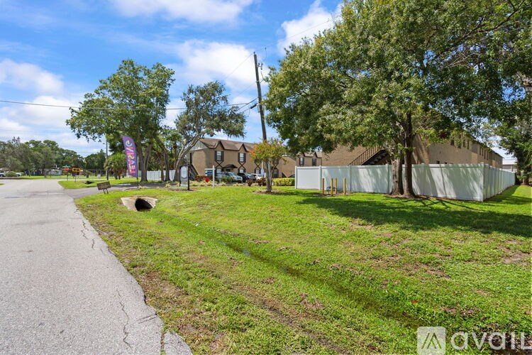A sunny day in a residential area with houses and greenery.