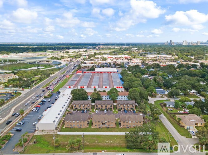 A bird's eye view of a suburban area with a large building and a parking lot.