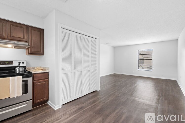 A kitchen with a stove, oven, and cabinets.