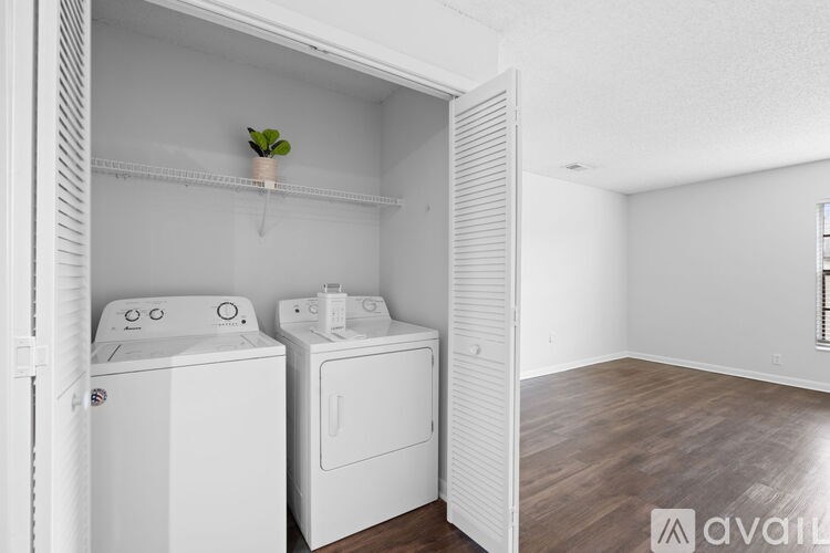A small laundry room with a washer and dryer.