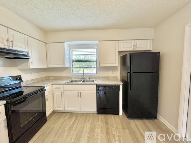 A kitchen with brown cabinets and a white door.