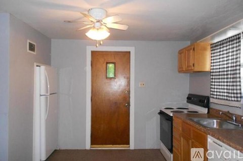 A kitchen with a refrigerator, stove, and sink.