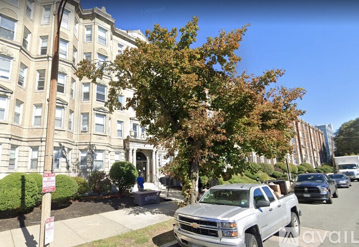 A white pickup truck is parked on the side of a street.