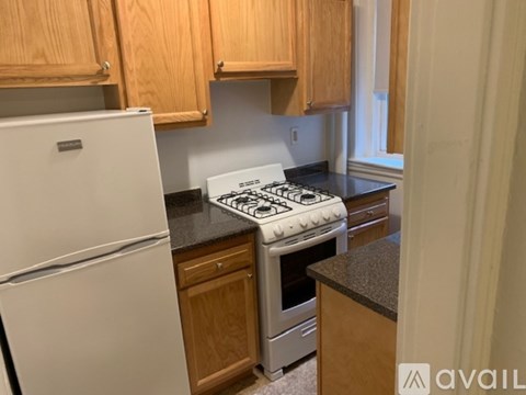 A kitchen with a white fridge and a white stove top.