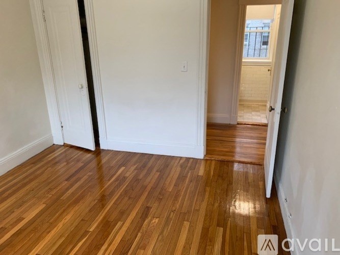 A room with wooden floors and white walls.
