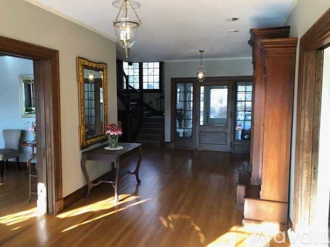 A room with wooden floors and a chandelier.