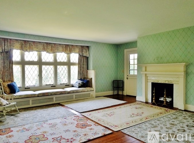 A dining room with a chandelier, a fireplace, and a table set for six.