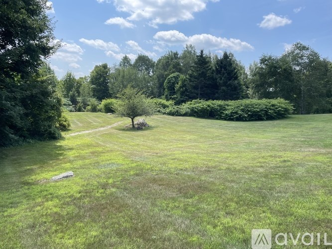 A bathroom with a toilet, sink, and mirror.