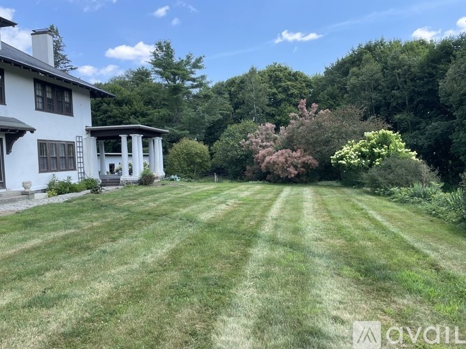 A hallway with floral wallpaper and a white door.