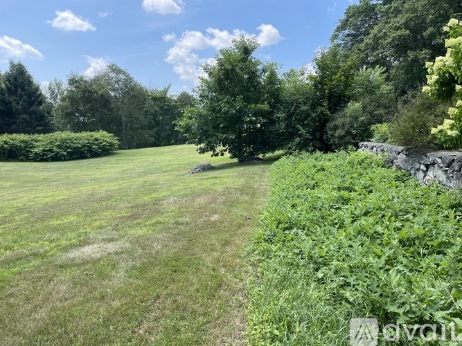 A room with a large window and a radiator on the floor.