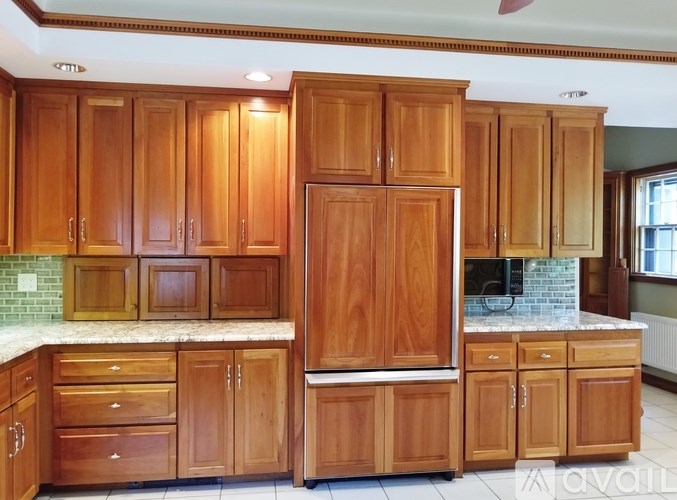 A room with a bench and two windows.