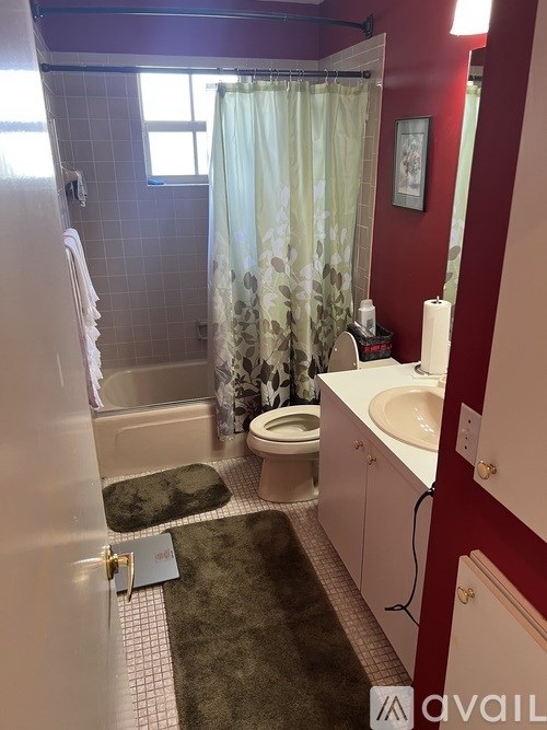A bathroom with a toilet, sink, and shower.