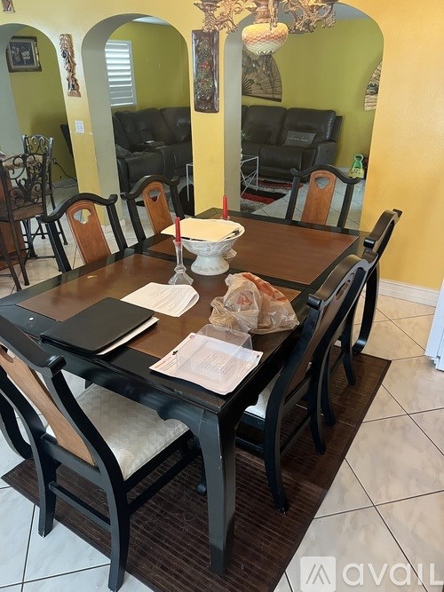 A dining room with a table set for two.
