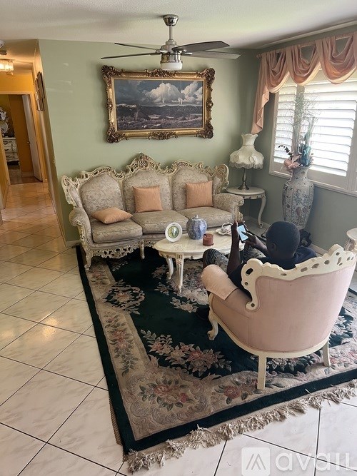 A living room with a couch, chair, and rug.