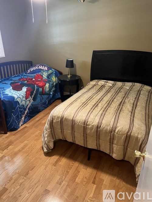 A bedroom with a bed and a nightstand.