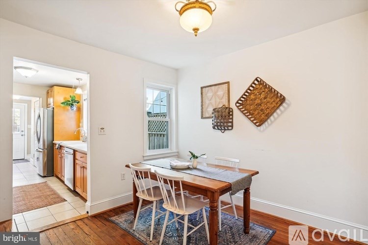 A dining room with a wooden table and chairs.