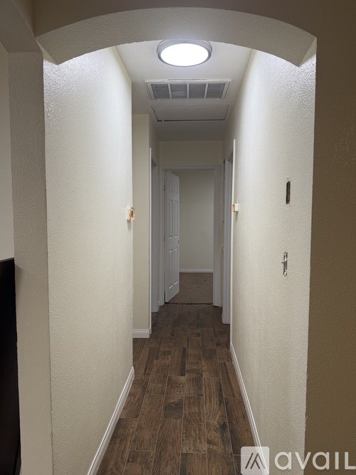 A long hallway with a light on the ceiling.