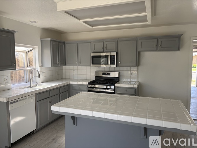 A kitchen with a white countertop and a black oven.