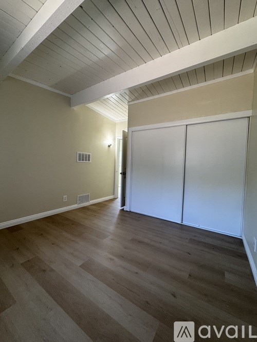 A room with wooden floors and white walls.