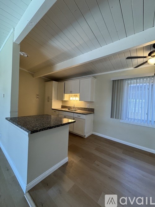 A kitchen with a countertop and cabinets.