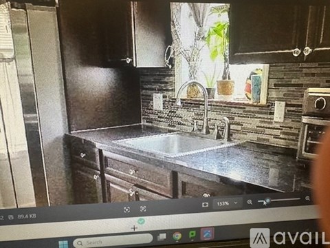 A kitchen with a sink and a window.